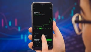 Trading grafiek telefoon Nederlanders verdienen met ‘niks’ doen - ‘AI’ start-up zorgt voor de winst