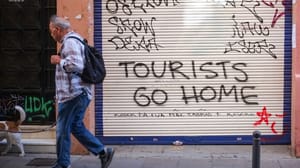 Een afbeelding van grafitti op een garagedeur in Barcelona tegen toerisme door overtoerisme en een woningcrisis Een afbeelding van grafitti op een garagedeur in Barcelona tegen toerisme door overtoerisme en een woningcrisis
