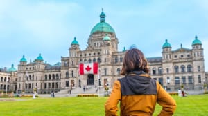 Tourist, Standing, In, Front, Of, The, Impressive, Parliament, Buildings, , Proudly Parlementsgebouw in Canada