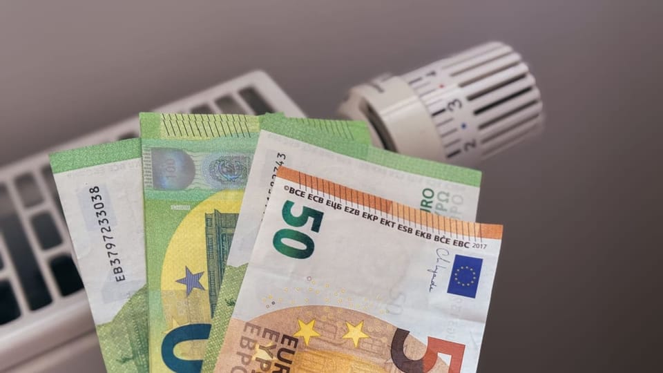 Een afbeelding van een aantal euro banbiljetten bij een verwarming, die het betalen van de energierekening moeten vertegenwoordigen