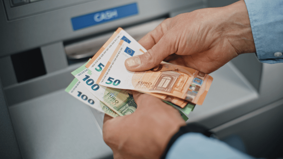 Man neemt eurobiljetten op van pinautomaat